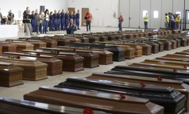 Coffins of died migrants are lined up inside an hangar of Lampedusa's airport, Italy, Saturday, Oct. 5, 2013. A ship carrying African migrants towards Italy capsized Thursday off the Sicilian island of Lampedusa after the migrants on board started a fire to attract attention. Just 155 people survived, 111 bodies have been recovered and more than 200 are still missing. The tragedy has prompted outpourings of grief and calls for a comprehensive EU immigration policy to deal with the tens of thousands fleeing poverty and strife in Africa and the Middle East. (AP Photo/Luca Bruno)