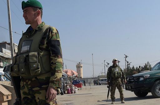 Afghan security personnel keep watch near the largest US military base in Bagram, 50 km north of Kabul, after an explosion on November 12, 2016. Four people were killed November 12 in an explosion inside the largest US military base in Afghanistan, NATO said, with local officials blaming a suicide attacker posing as a labourer for the major security breach. / AFP PHOTO / SHAH MARAI