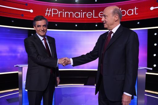The two finalists in France's conservative presidential primary Alain Juppe (R) and Francois Fillon (L) shake hands, prior to taking part in the first televised debate between the two remaining candidates for the right-wing Les Republicains (LR) party primaries in Paris on November 24, 2016, ahead of the 2017 presidential election. France's conservative presidential favourite Francois Fillon struck a confident tone ahead of a final televised debate on November 24 with his rival Alain Juppe. A poll published on November 23 showed Fillon would win 65 percent of votes in the final primary vote on November 27 against 35 percent for the more centrist Juppe. / AFP PHOTO / POOL / Eric FEFERBERG